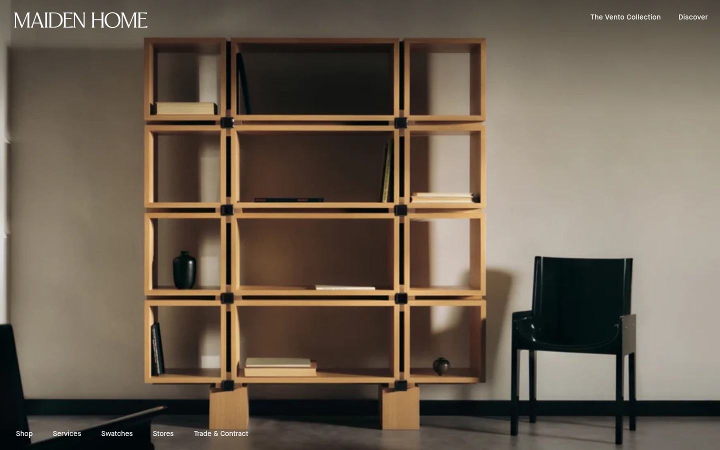Maiden Home homepage: an oak shelving unit and black leather chair